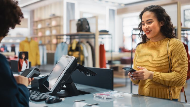 woman paying at till