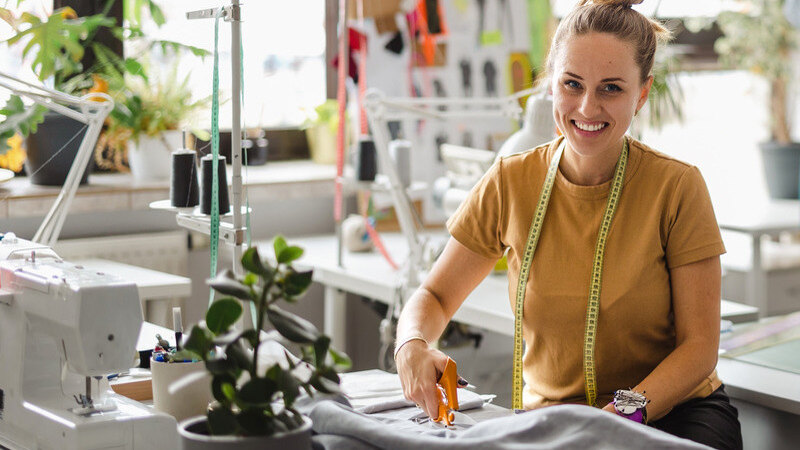 woman in craft shop cutting materials